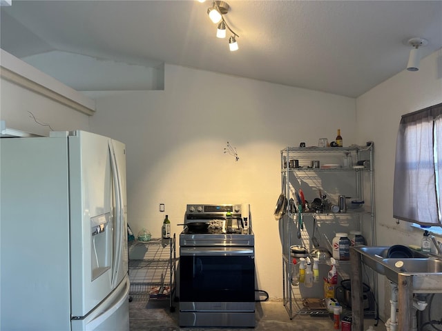 kitchen with stainless steel range with electric stovetop and white refrigerator with ice dispenser