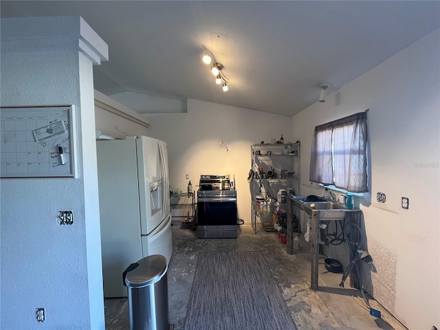 kitchen with lofted ceiling, stainless steel electric range, and white refrigerator with ice dispenser