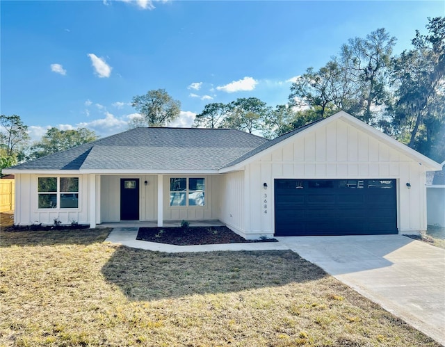 view of front of property with a garage and a front lawn