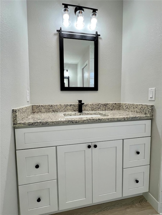 bathroom featuring vanity and wood finished floors