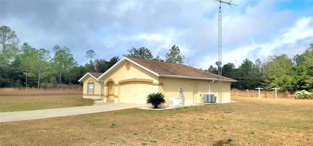 view of home's exterior with a garage, ac unit, cooling unit, and a lawn