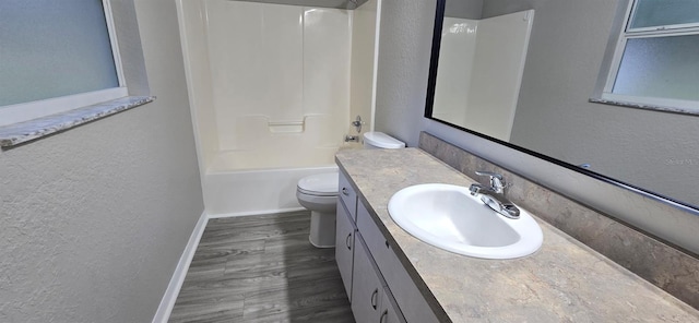 full bathroom with vanity, wood-type flooring, tub / shower combination, and toilet