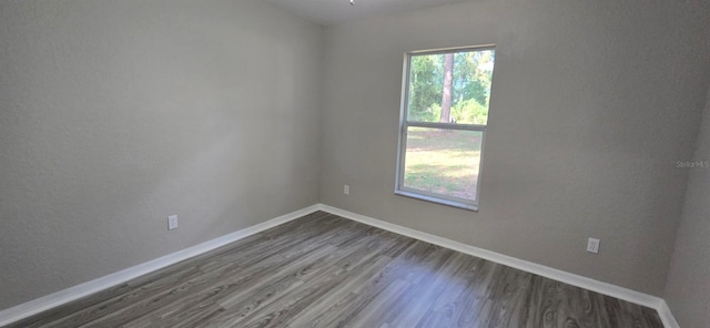 unfurnished room with hardwood / wood-style flooring