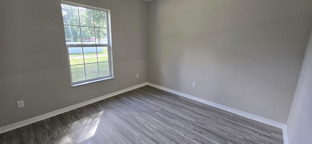 unfurnished room with hardwood / wood-style floors