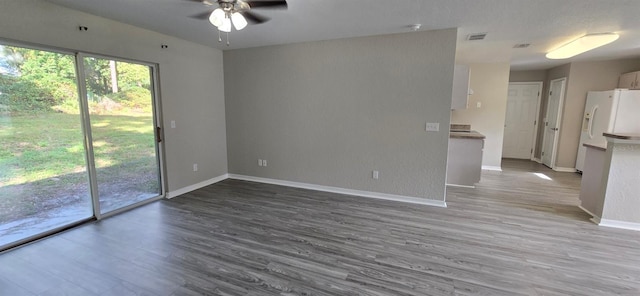 empty room with hardwood / wood-style flooring and ceiling fan