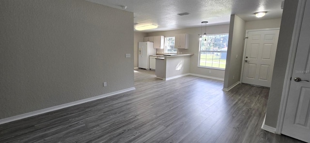 interior space with dark hardwood / wood-style flooring and a textured ceiling