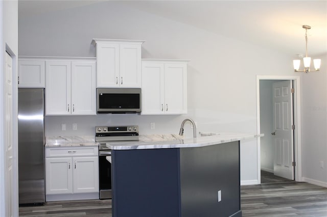 kitchen with stainless steel appliances, decorative light fixtures, vaulted ceiling, and white cabinets