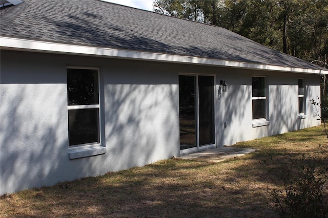 rear view of property featuring a yard