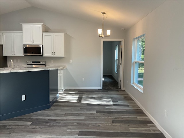 kitchen with vaulted ceiling, dark hardwood / wood-style floors, stainless steel appliances, light stone countertops, and white cabinets