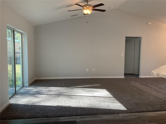 carpeted empty room with vaulted ceiling and ceiling fan