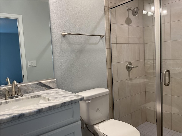 bathroom with vanity, toilet, and an enclosed shower