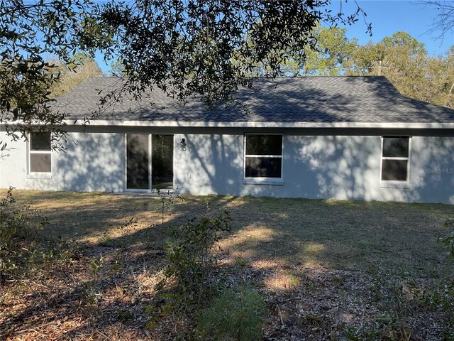 back of house with a yard