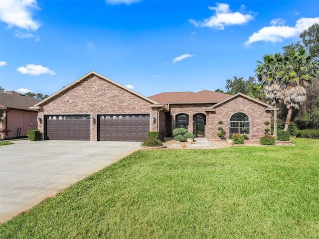 view of front of home featuring a garage and a front yard