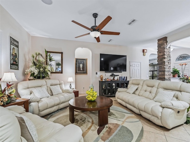 tiled living room featuring ceiling fan and ornate columns