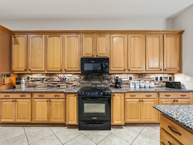 kitchen featuring tasteful backsplash, light tile patterned floors, black appliances, and dark stone counters