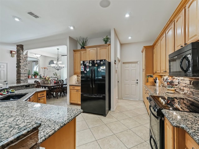 kitchen featuring light tile patterned flooring, decorative columns, sink, dark stone countertops, and black appliances