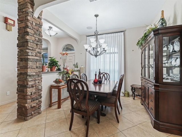 dining room featuring light tile patterned flooring and a chandelier