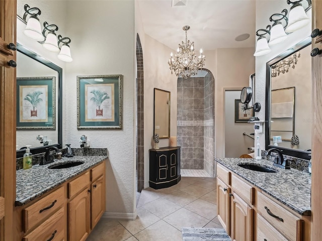 bathroom featuring vanity, tile patterned flooring, and a notable chandelier