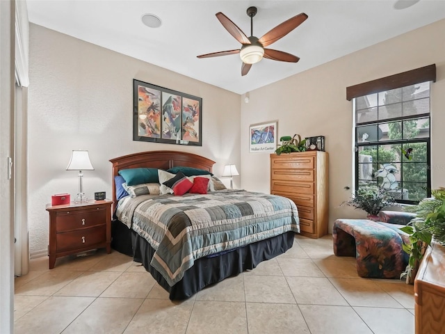 tiled bedroom with ceiling fan