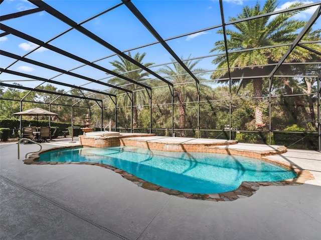 view of swimming pool featuring an in ground hot tub, glass enclosure, and a patio