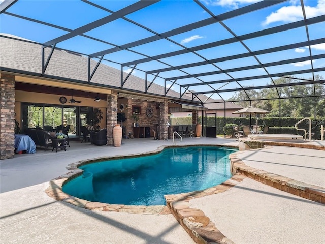 view of pool with ceiling fan, a lanai, and a patio area