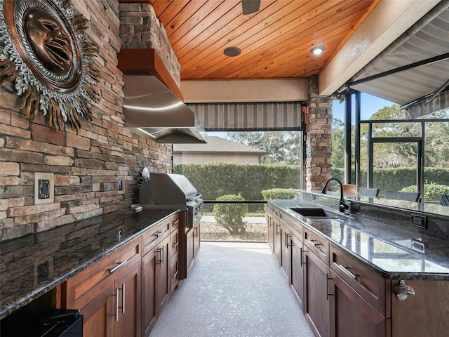 view of patio featuring exterior kitchen, sink, and grilling area