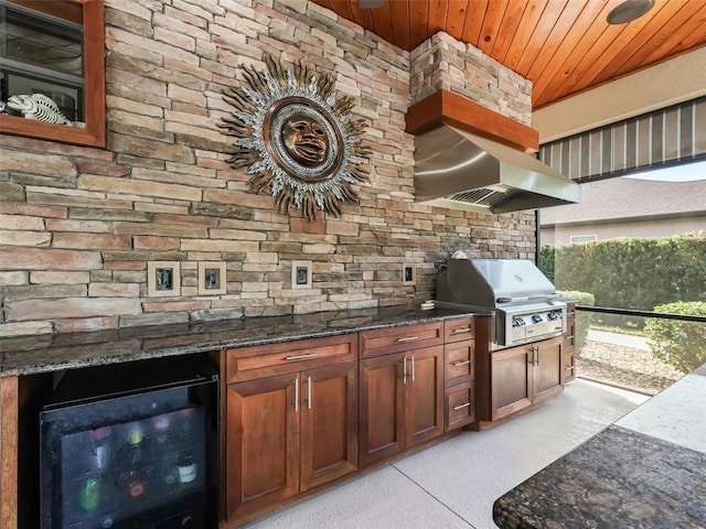 exterior space with wine cooler, grilling area, and exterior kitchen