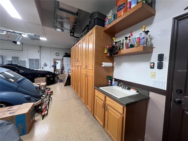 garage with sink and electric panel