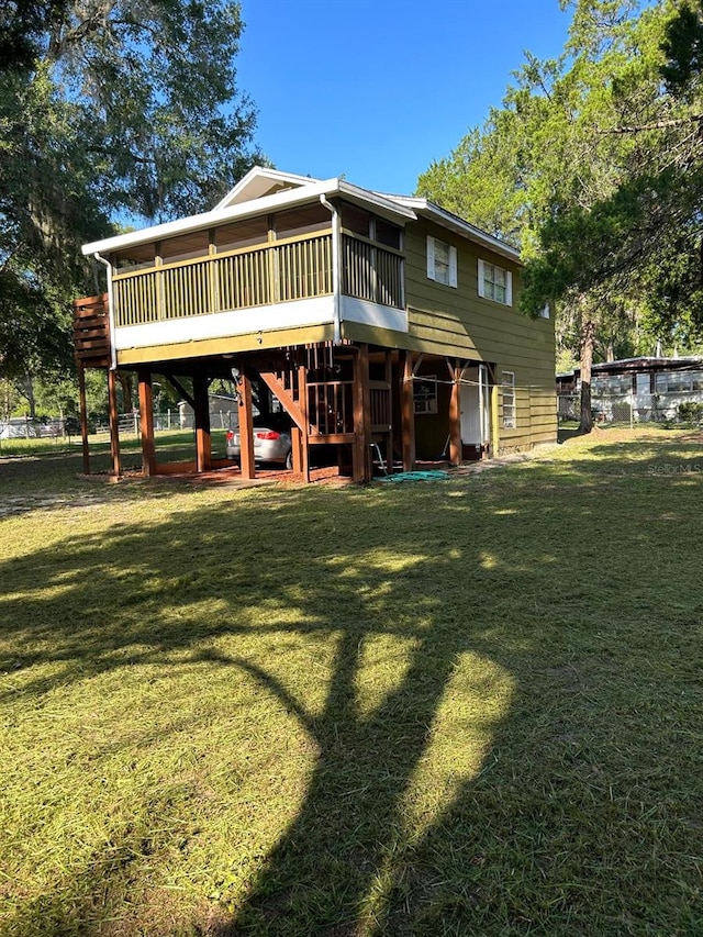 rear view of house featuring a lawn