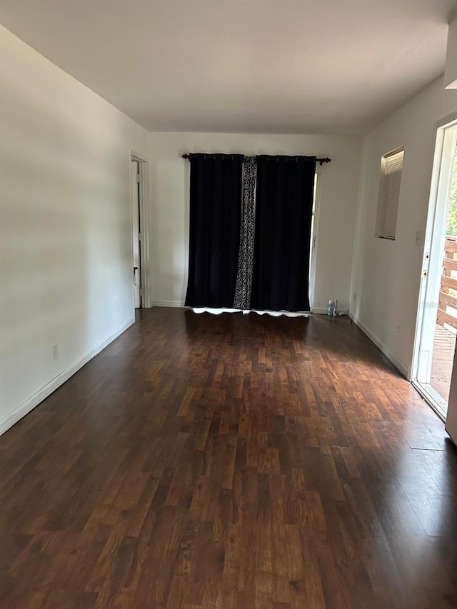 unfurnished room featuring dark hardwood / wood-style floors