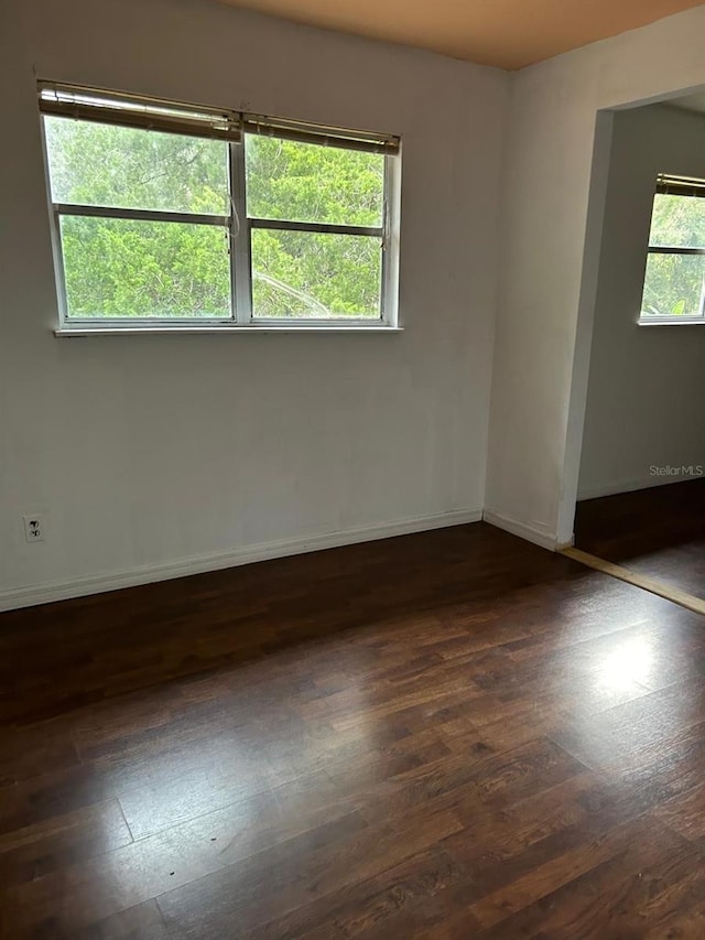 spare room featuring dark hardwood / wood-style floors