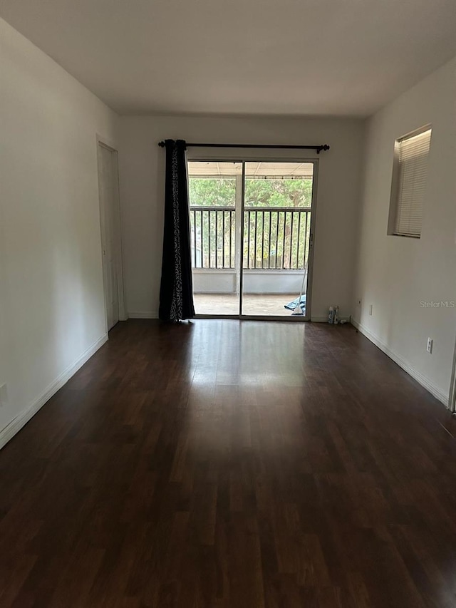 empty room featuring dark wood-type flooring