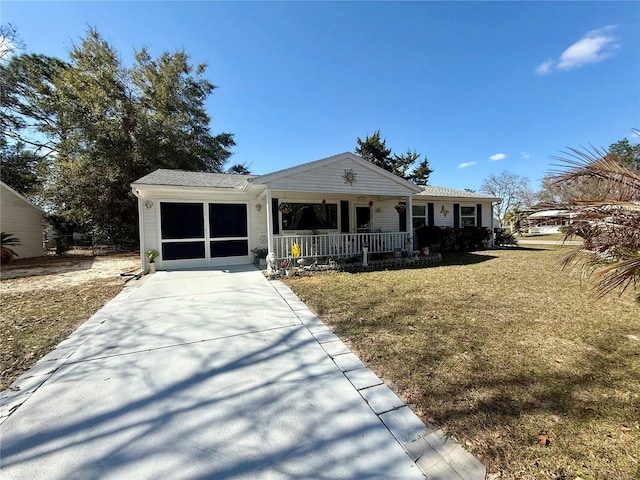 view of front facade featuring a porch, a garage, and a front yard