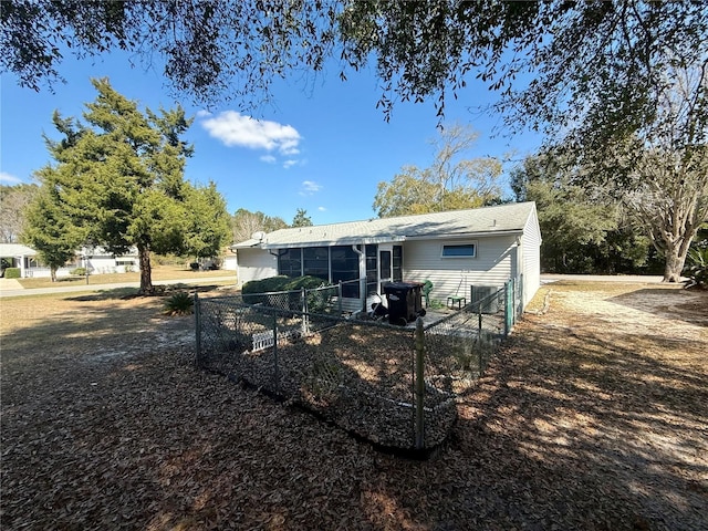 rear view of house featuring a sunroom