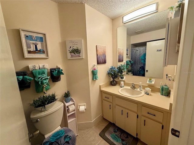 full bath with baseboards, toilet, tile patterned floors, a textured ceiling, and vanity