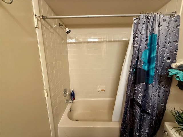 bathroom featuring shower / bath combo and toilet