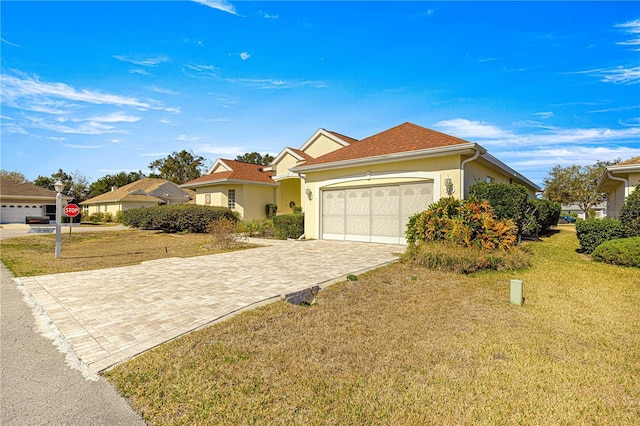 ranch-style house featuring a garage and a front yard