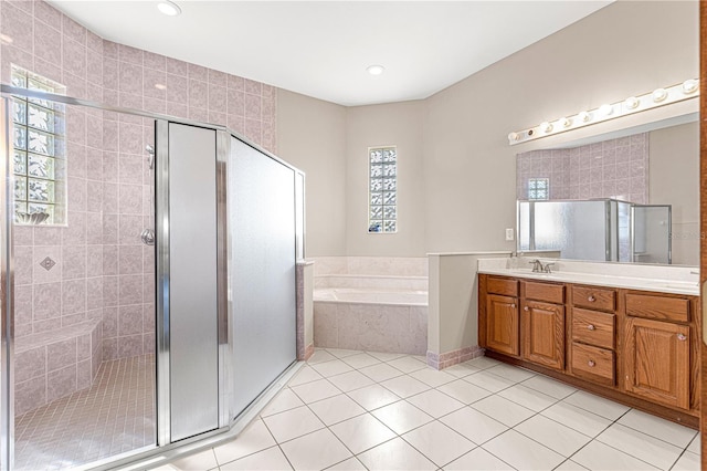 bathroom with vanity, shower with separate bathtub, and tile patterned floors