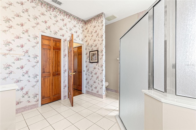 hall with light tile patterned flooring