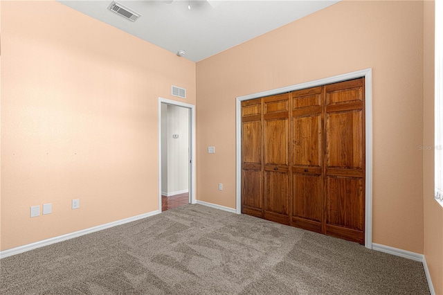 unfurnished bedroom featuring light carpet, a closet, and ceiling fan