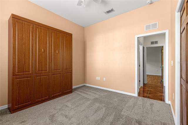 unfurnished bedroom with ceiling fan and light carpet