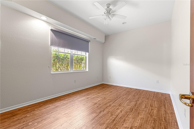 unfurnished room with hardwood / wood-style floors and ceiling fan