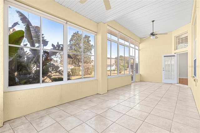 unfurnished sunroom with ceiling fan