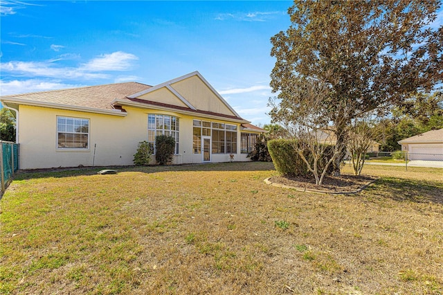 rear view of property with a yard