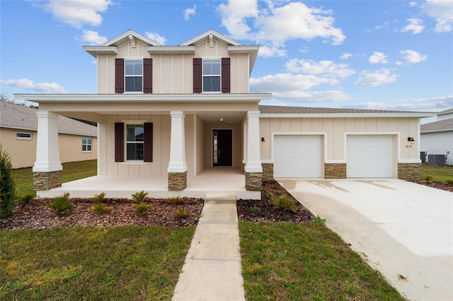 view of front of home with a garage, a front yard, covered porch, and central air condition unit