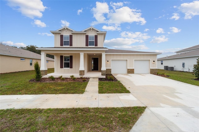 view of front of house featuring central AC unit, a garage, a front lawn, and a porch