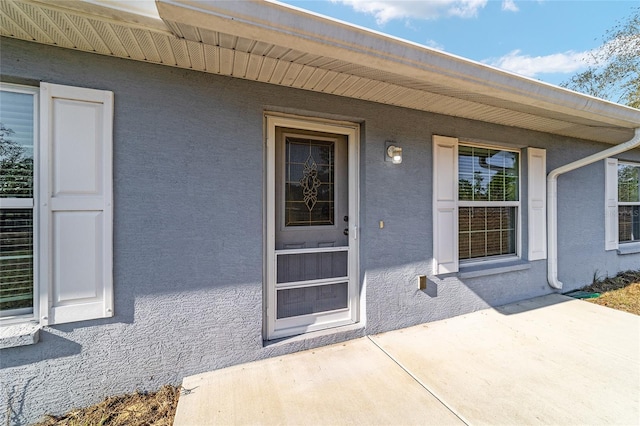 property entrance featuring a patio