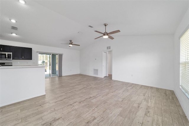 unfurnished living room featuring ceiling fan, lofted ceiling, and light hardwood / wood-style floors