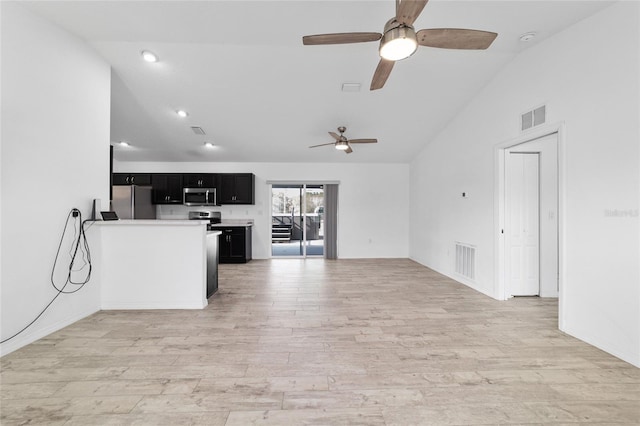 unfurnished living room featuring lofted ceiling and light hardwood / wood-style floors