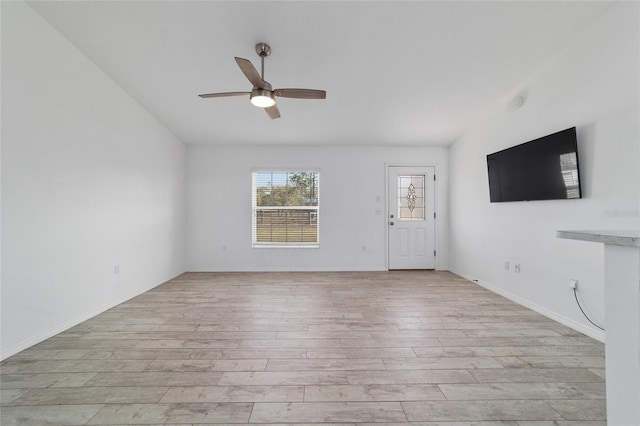 unfurnished living room featuring ceiling fan and light hardwood / wood-style floors